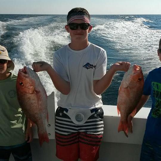 a group of people standing next to a body of water