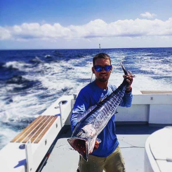 a man standing on a boat in the water